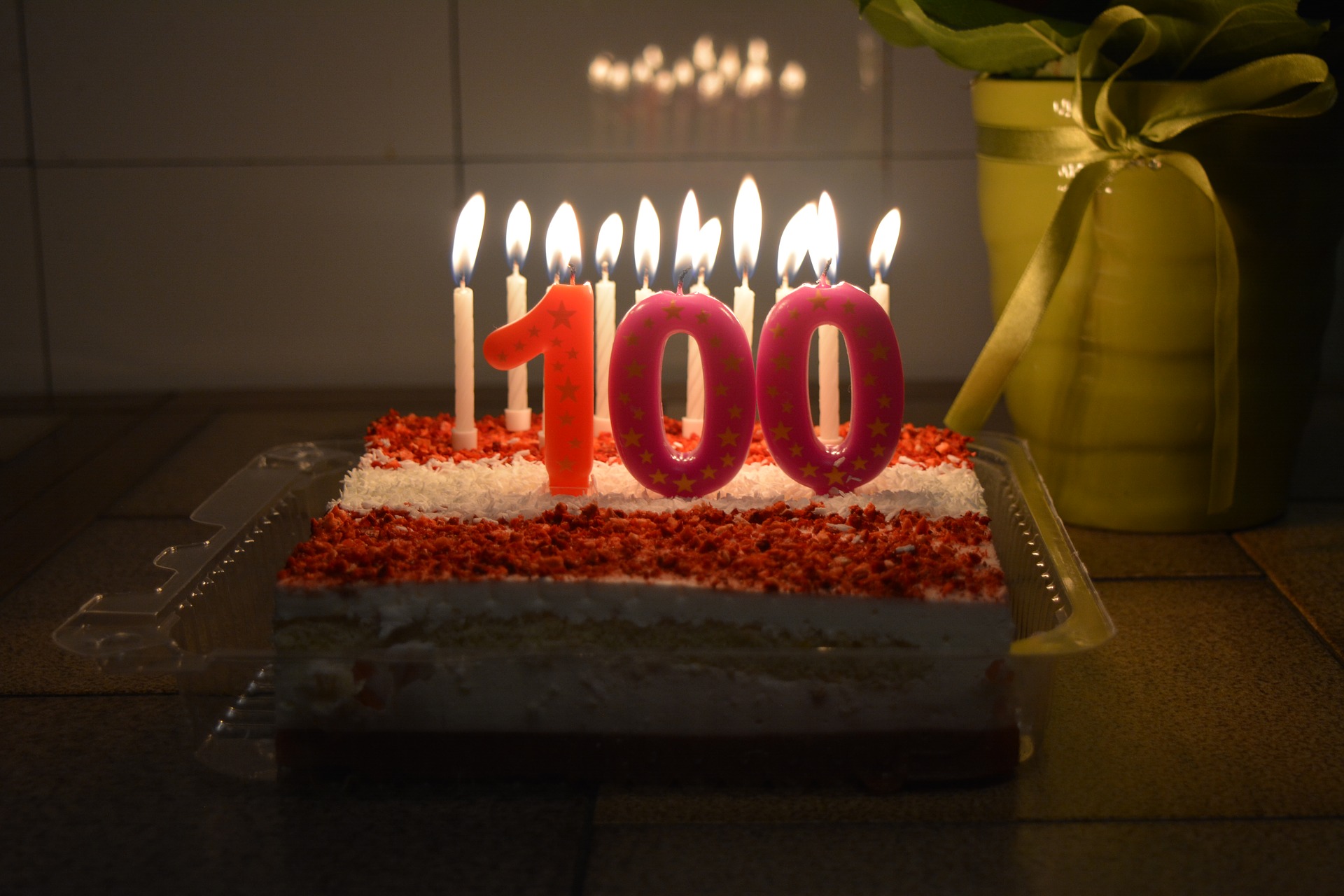 A cake with candles and the number 100